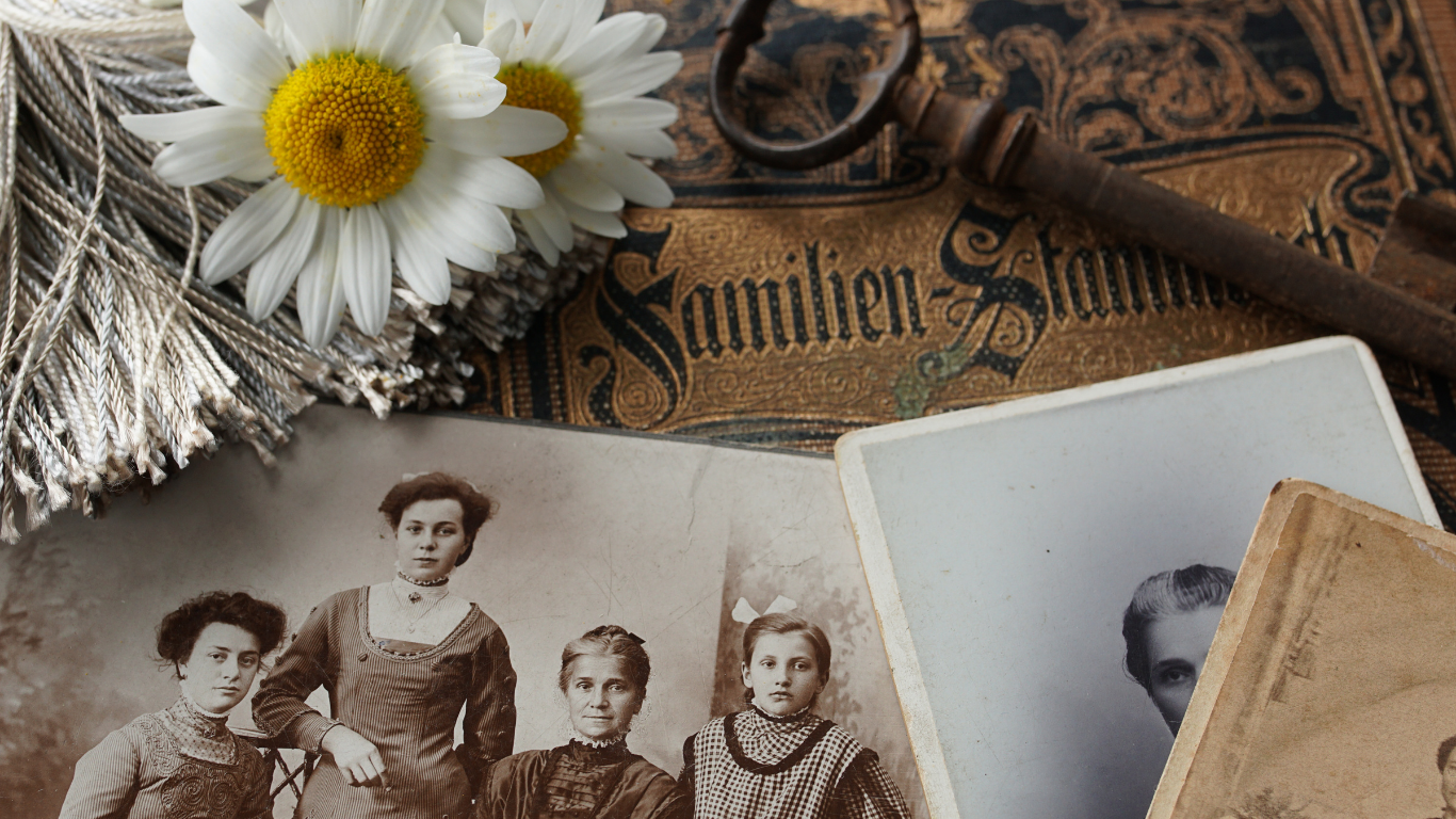 Layered personal objects representing years of carried grief — photographs, letters, mementos worn with time
