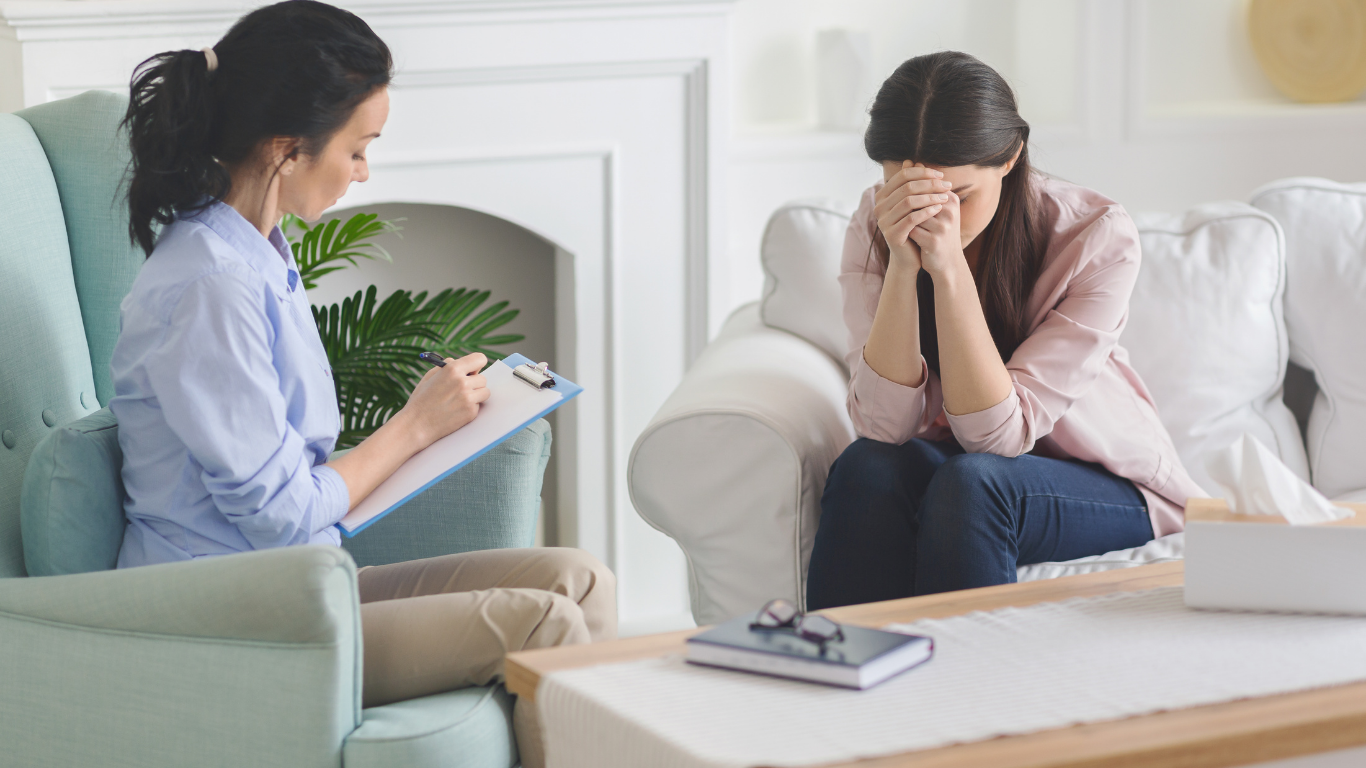 A licensed grief counselor listening attentively to a client during a grief therapy session in Bergen County NJ